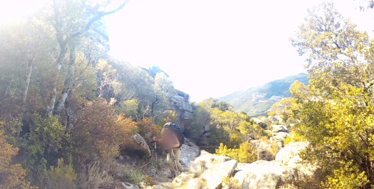 quelqu'un qui monte dans un chemin pentu en montagne